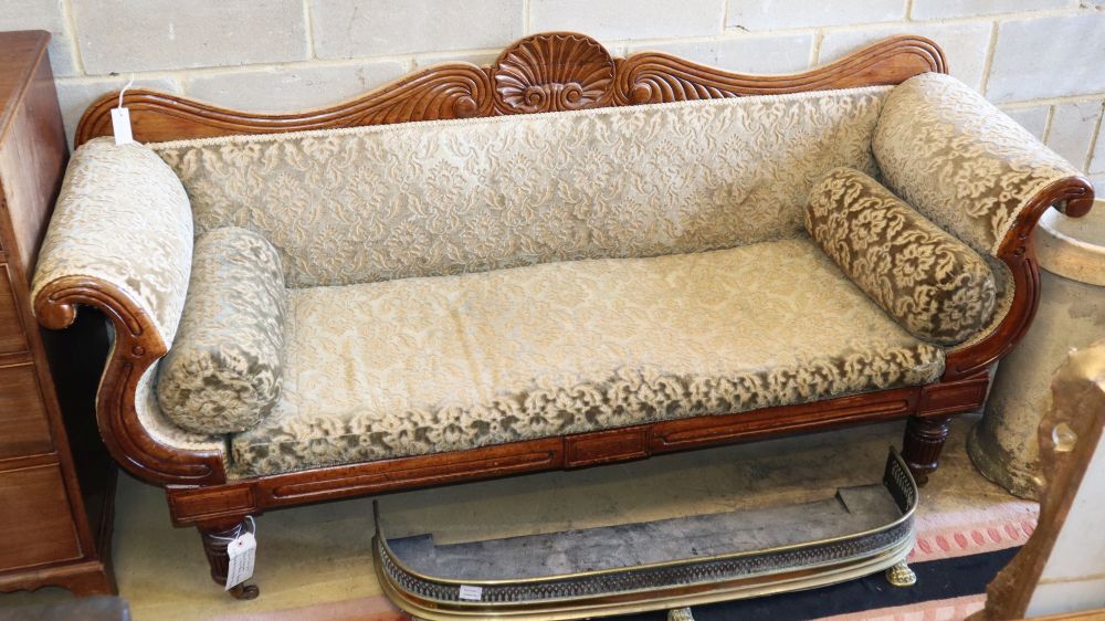 A William IV mahogany show frame settee with scallop shell back on original brass castors, W.197cm